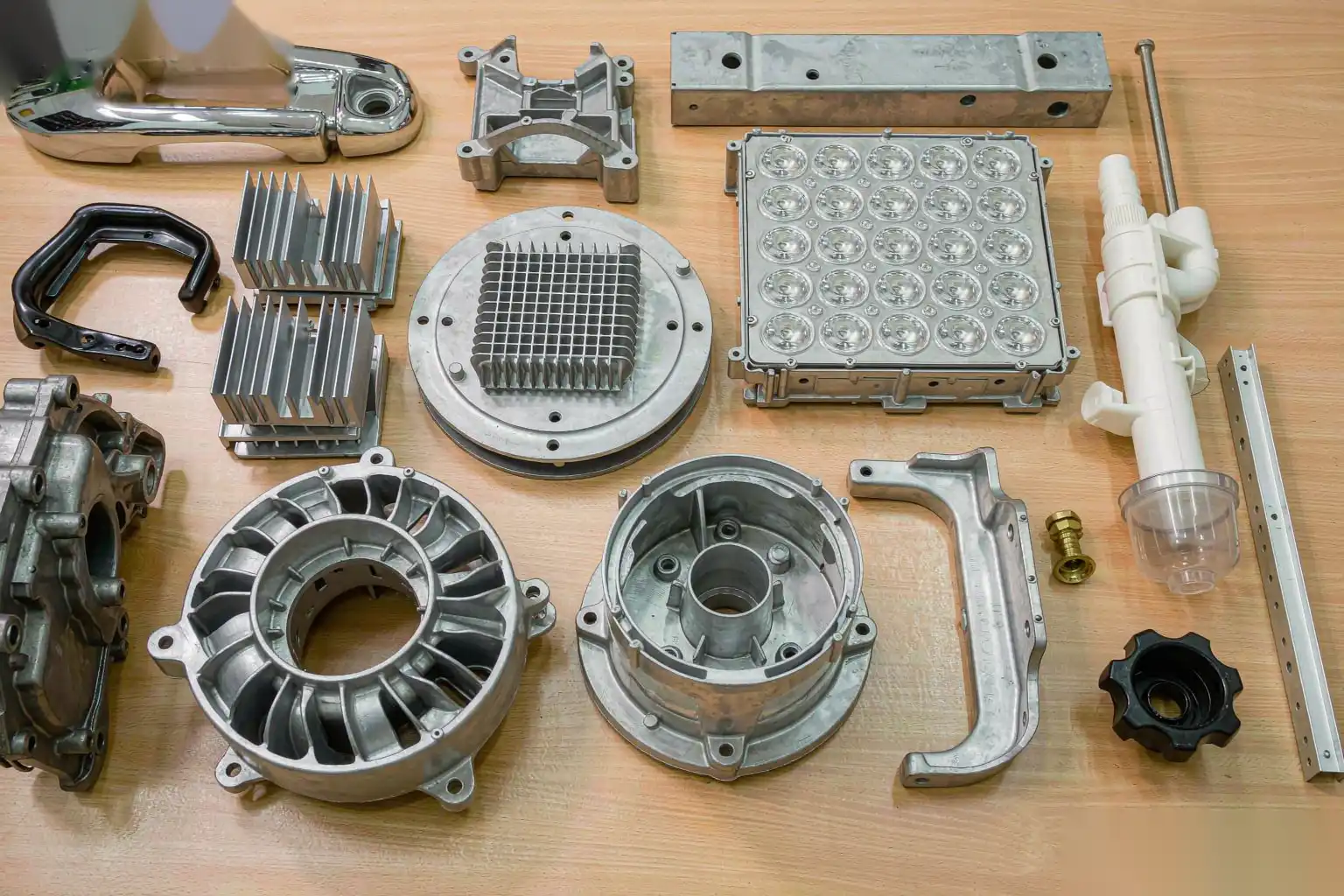 Various aluminum die cast parts: automotive, electronics, lighting, sanitary arranged in a grid