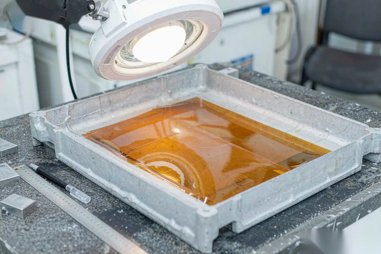 Die cast aluminum plates with protective coating undergoing inspection