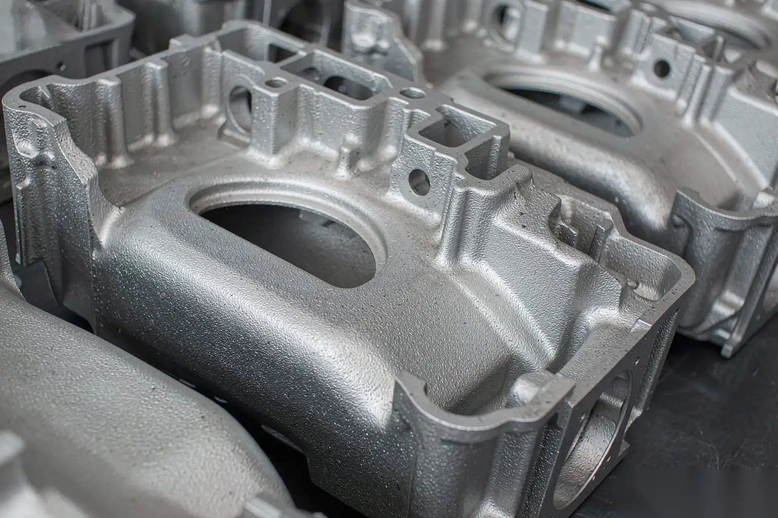 Aluminum die castings after shot blasting showing uniform surface