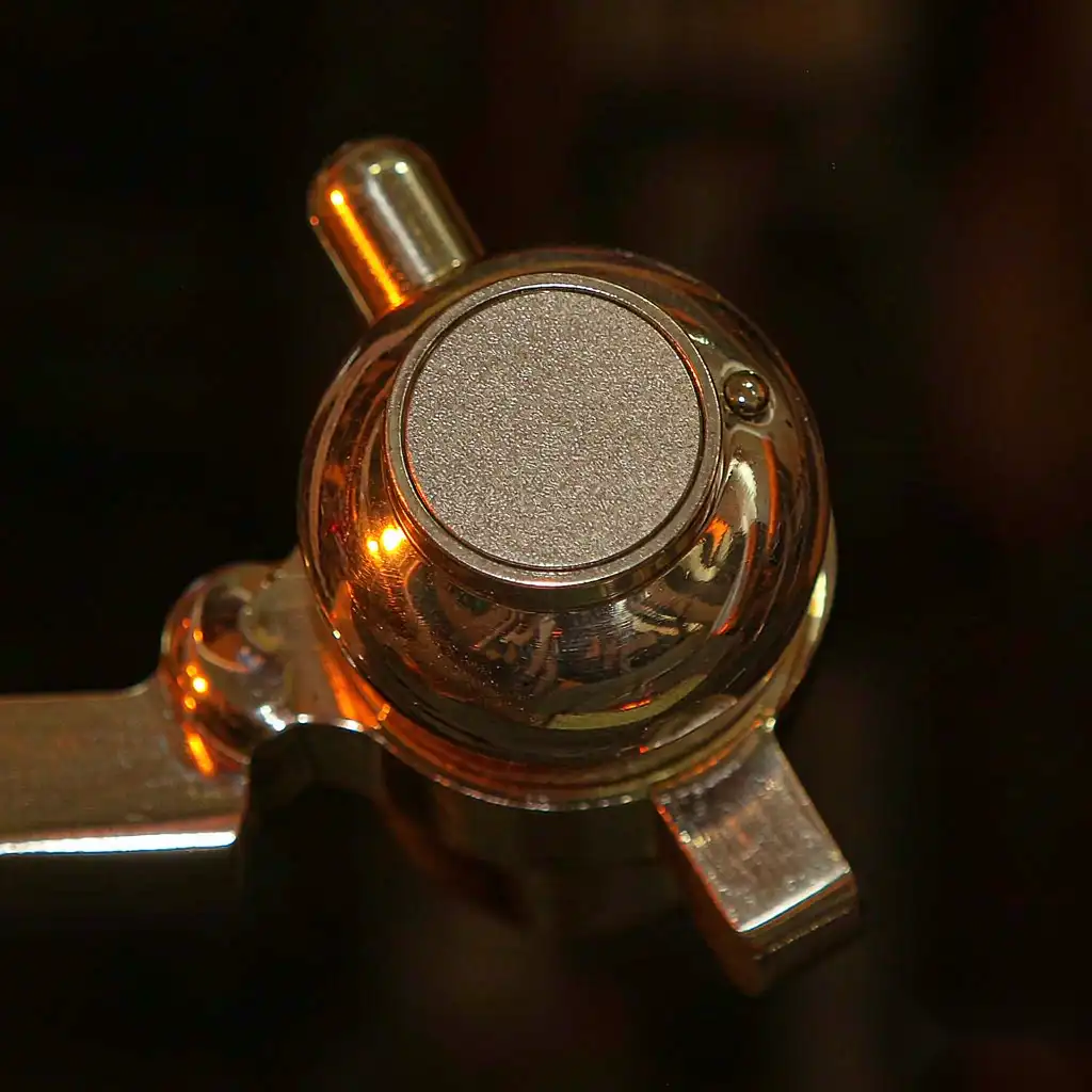 Finished brass ball valve sphere showing a precise round sealing surface under inspection