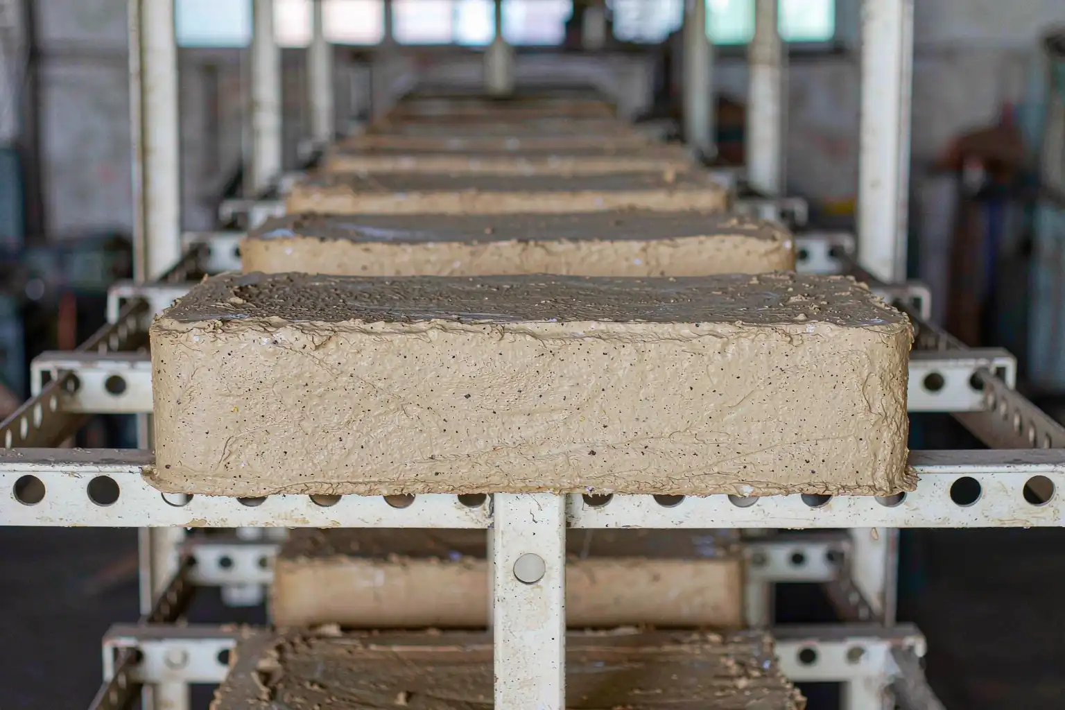 Finished cured sand cores stacked on a rack in a foundry