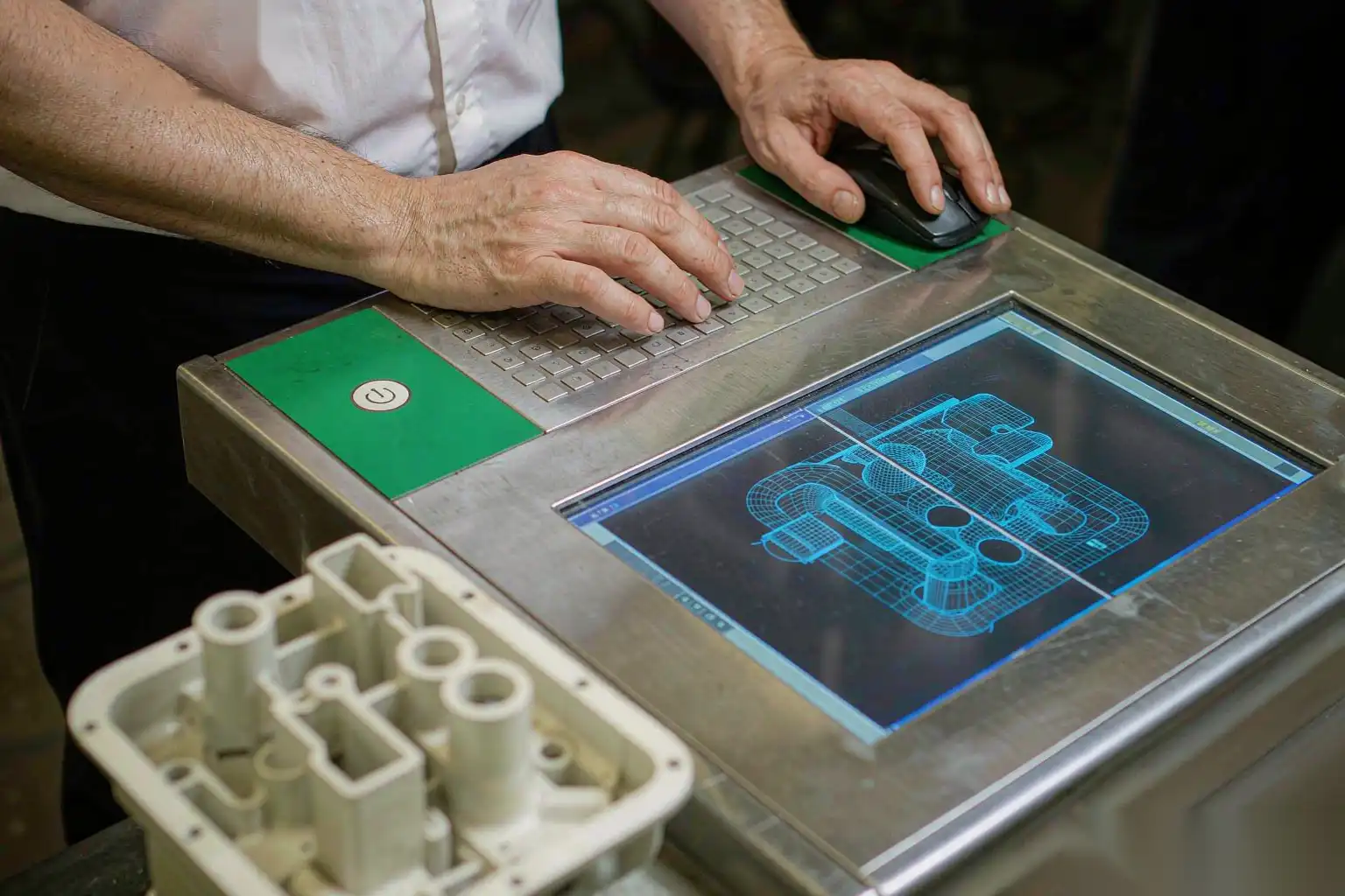 Inspector programming a CMM for a die cast part