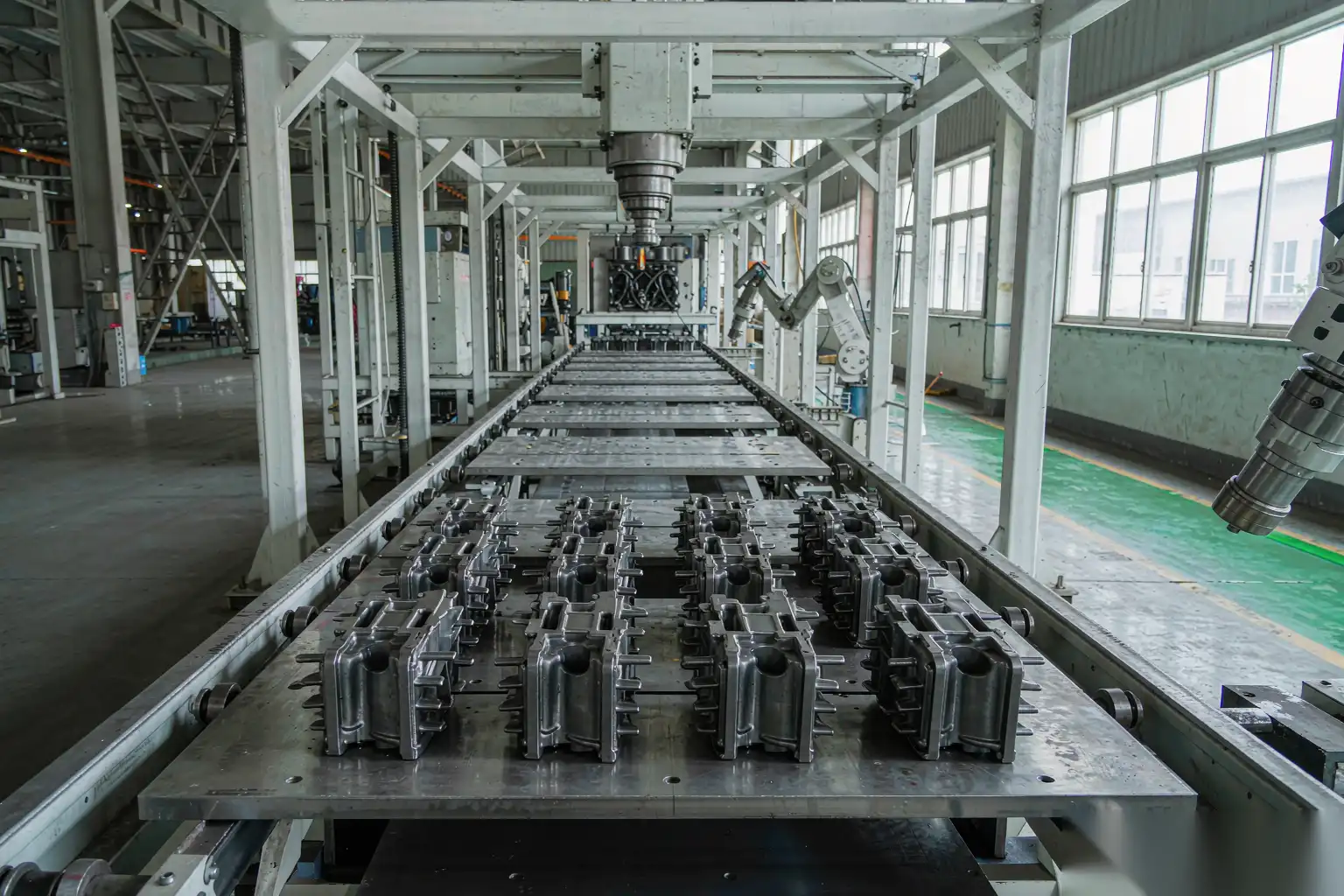 Secondary operations line with die-cast parts on a conveyor