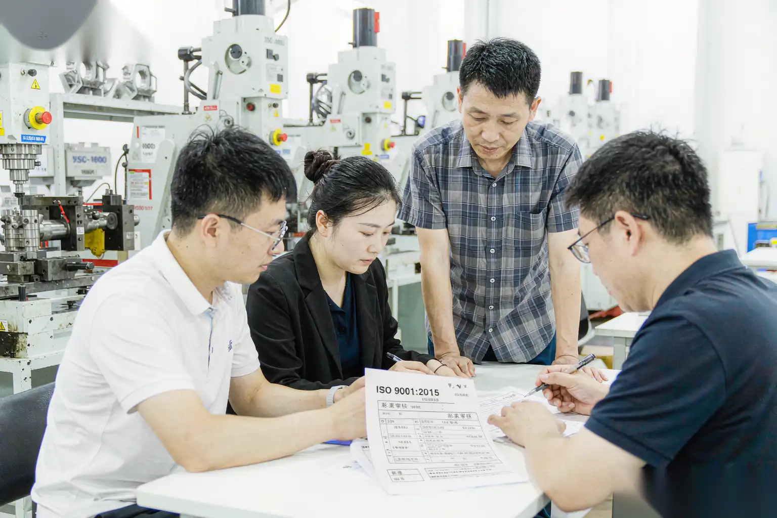 Team reviewing a die-casting supplier audit checklist in a meeting room