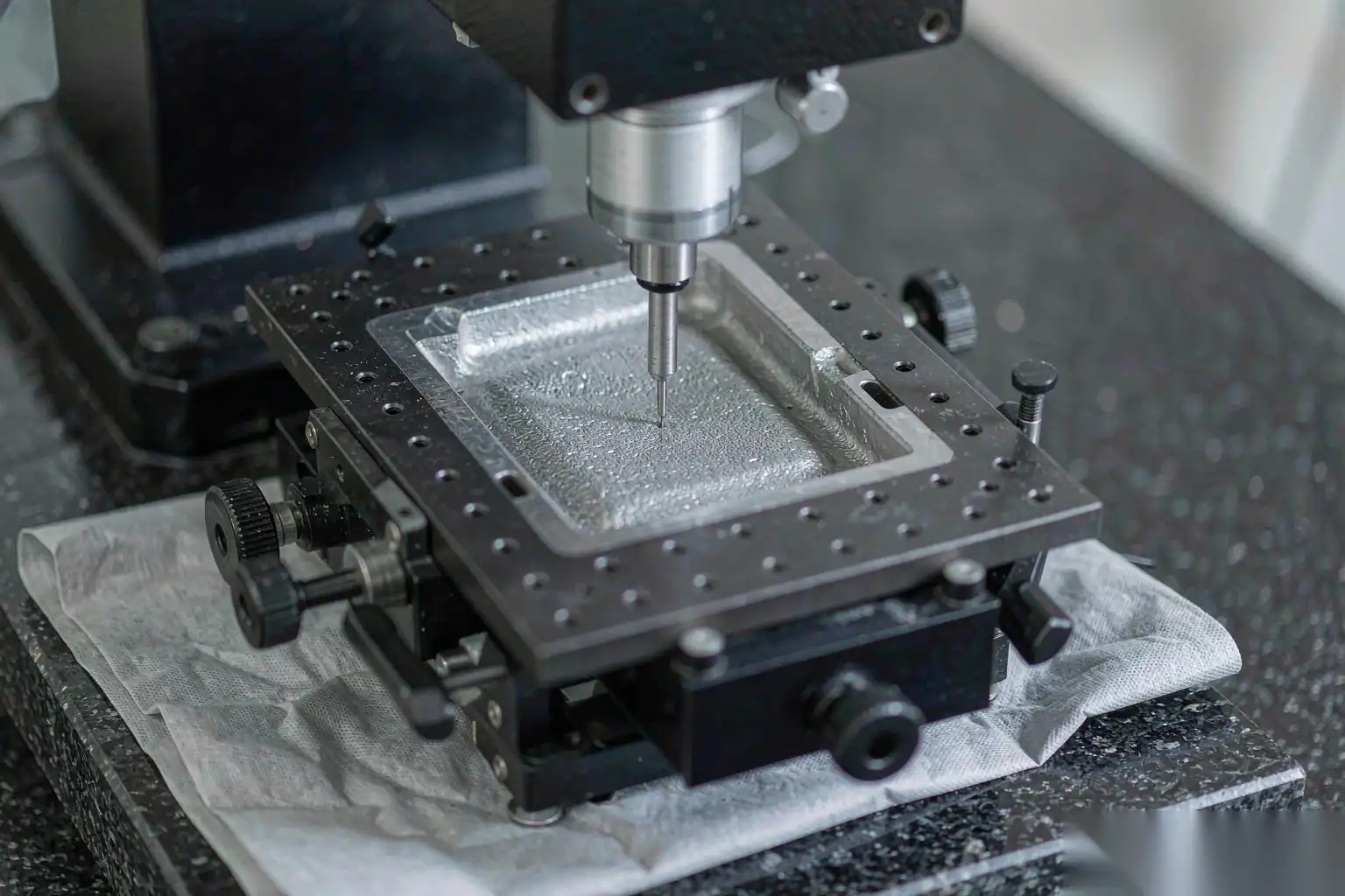 Surface profilometer measuring the Ra of a die cast aluminum sample part