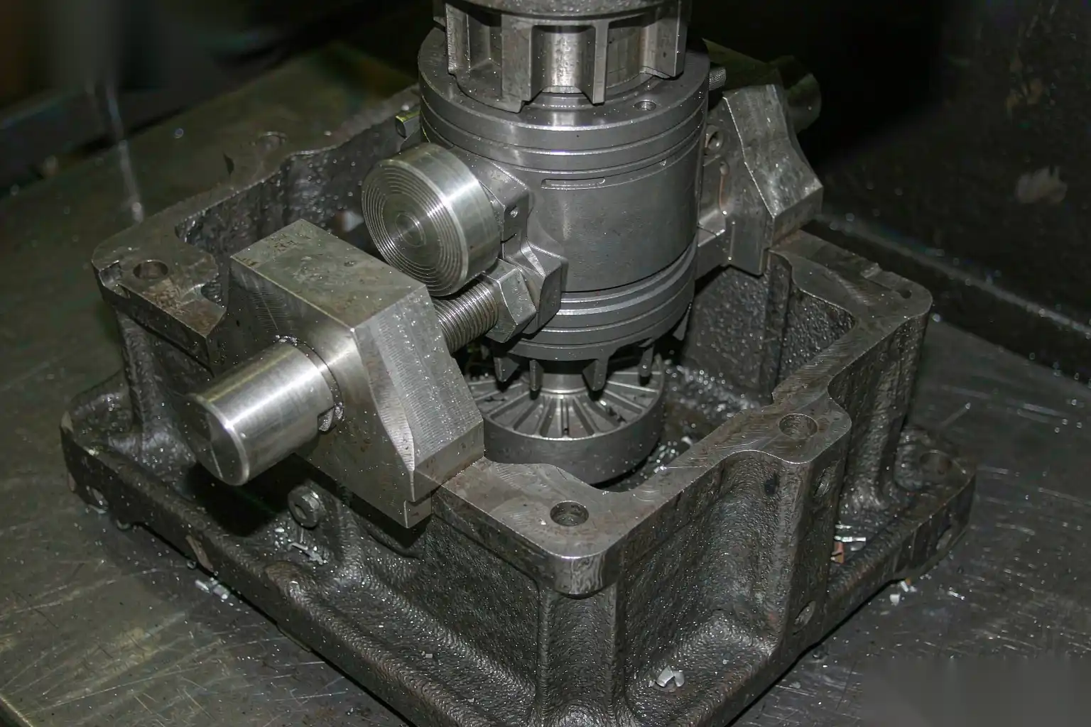 Die cast part in a trimming fixture removing gate and runner