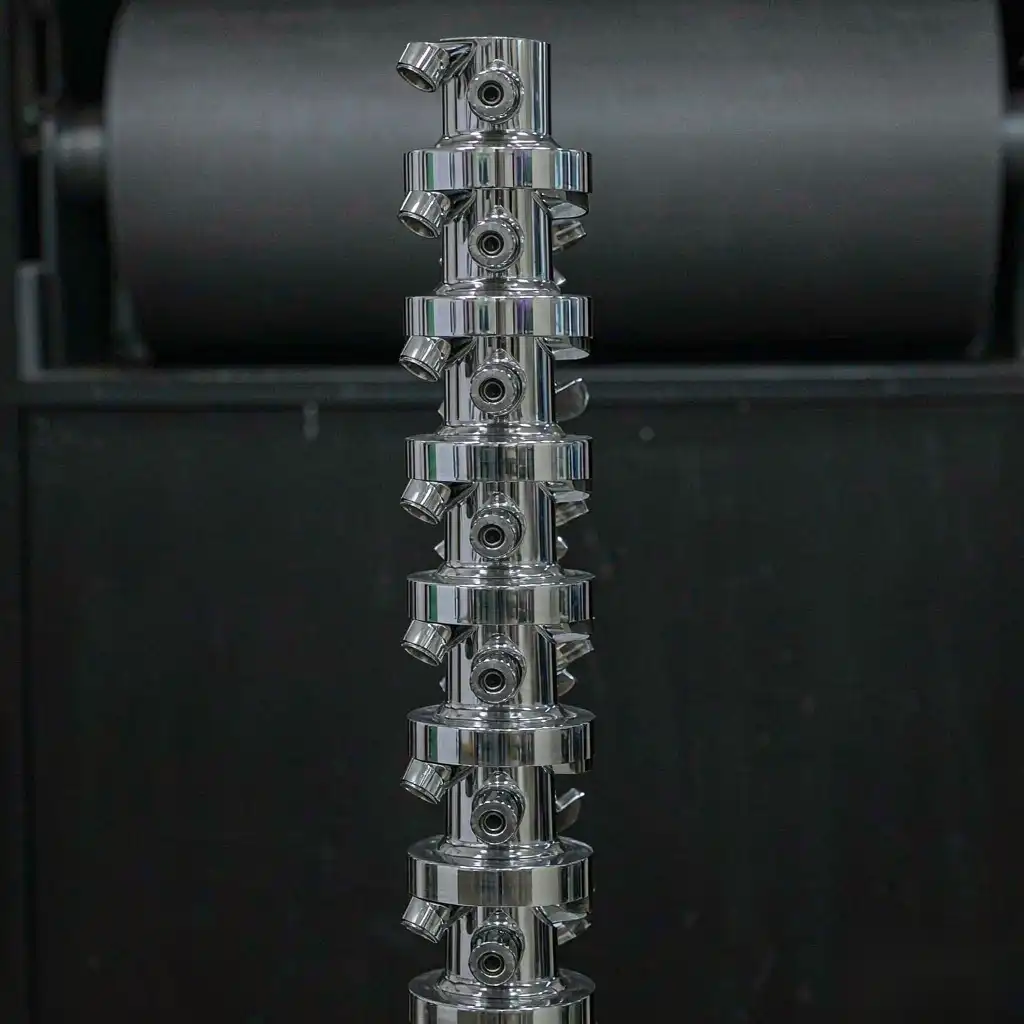 Stack of identical automated faucet bodies showing consistent finish and low scrap rate