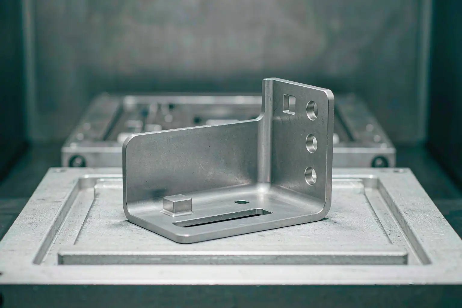 As-cast aluminum bracket component removed from a permanent steel mold