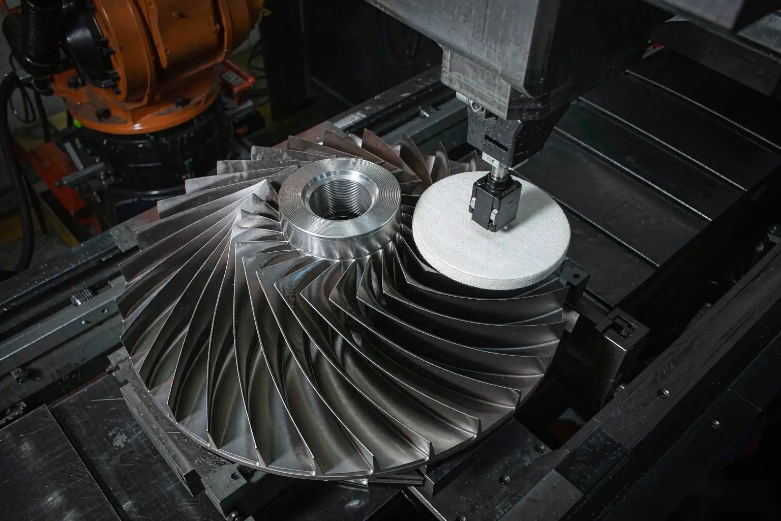 Robotic polishing cell finishing curved turbine impeller blades to a smooth surface
