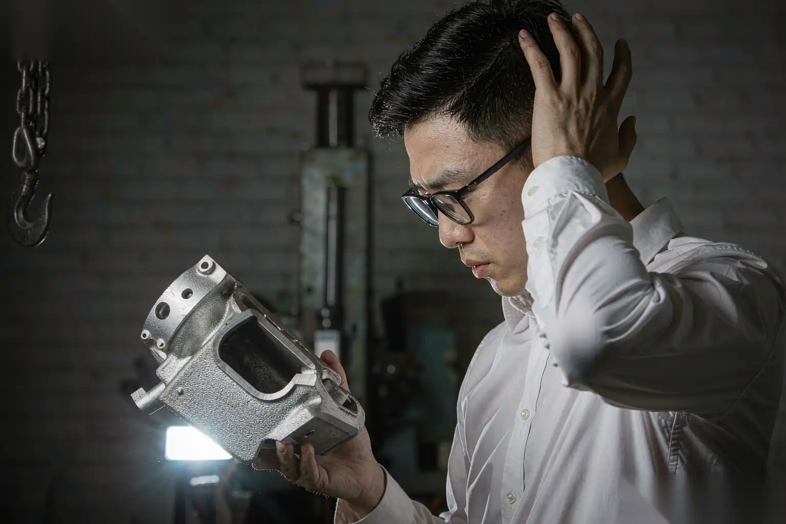 Engineer inspecting a magnesium die cast component