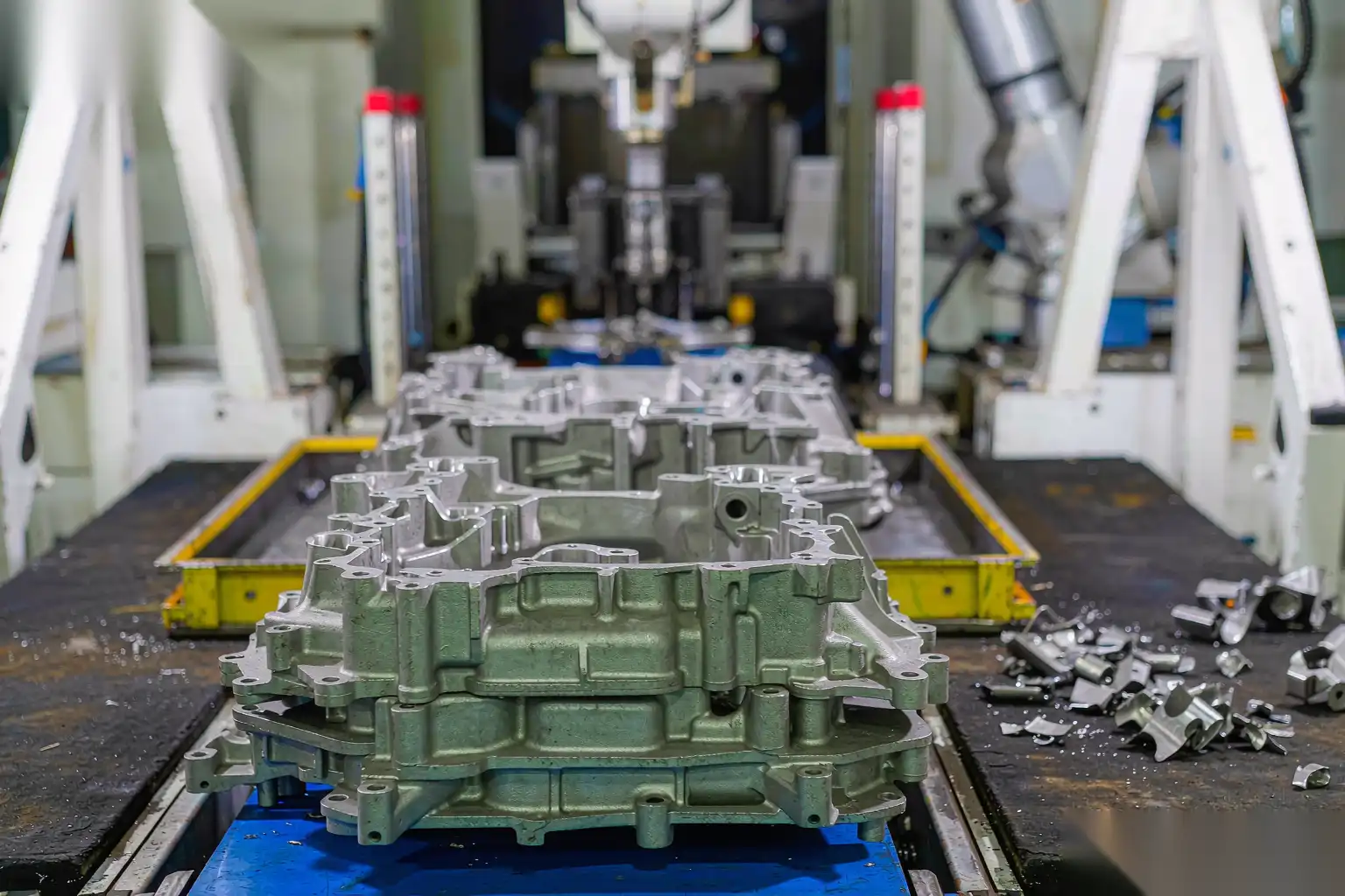Rows of finished magnesium die-cast components laid out for inspection
