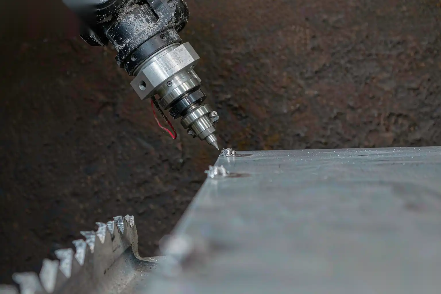 Close up of robotic deburring tool removing a burr