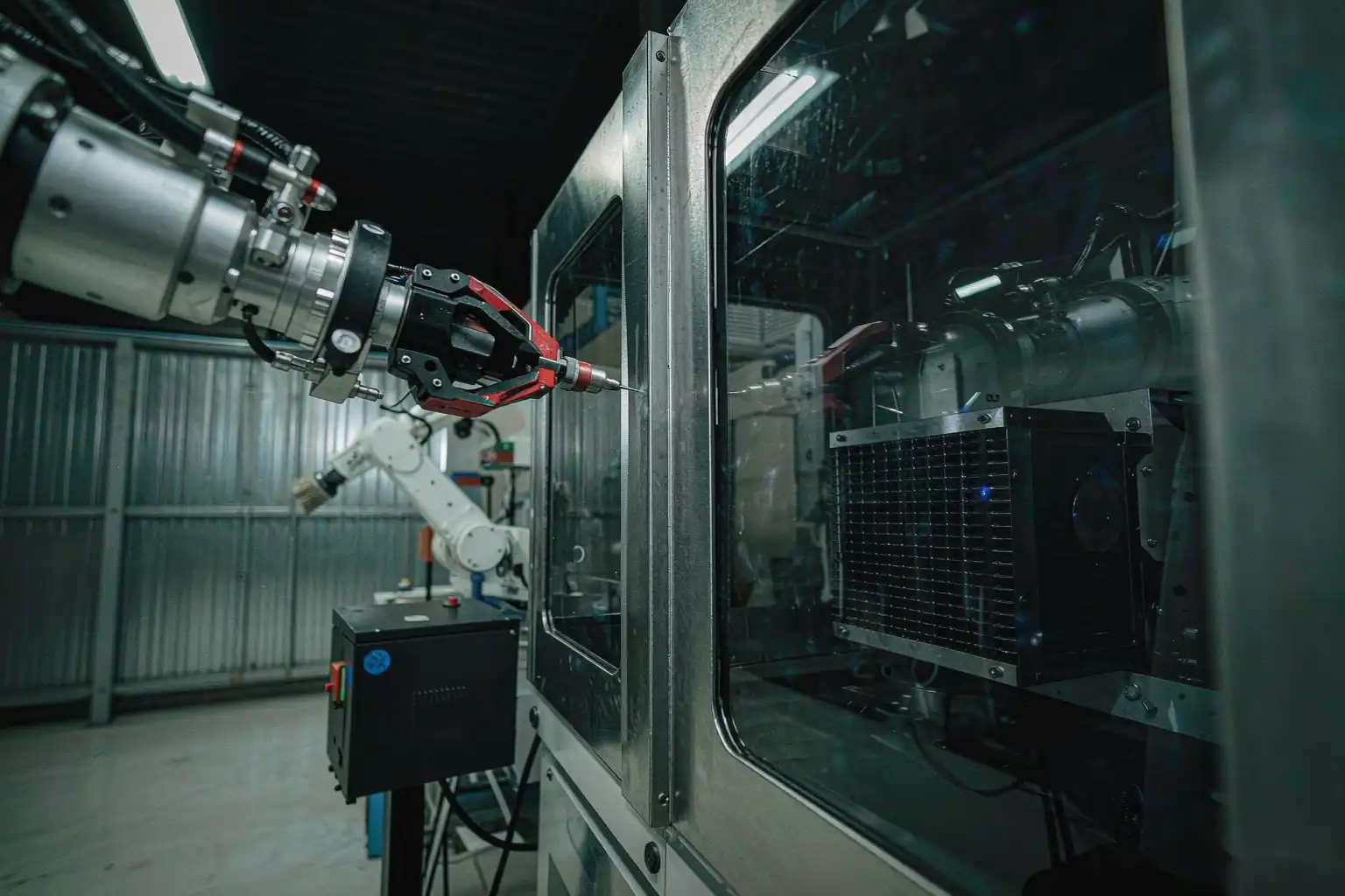 Robotic finishing cell deburring and polishing an electronic enclosure without scratching the surface